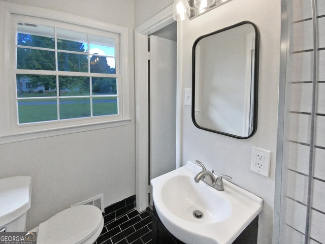 bathroom with vanity, toilet, and tile patterned floors