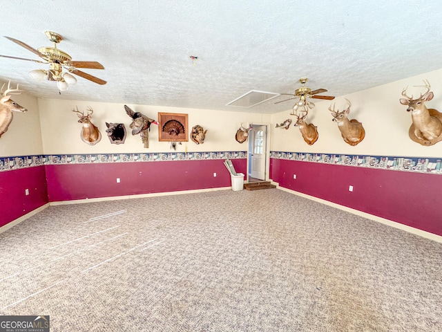 interior space featuring ceiling fan, a textured ceiling, and carpet