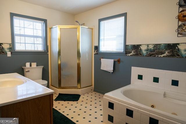 full bathroom featuring vanity, toilet, and separate shower and tub