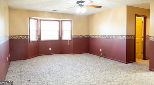 spare room with light colored carpet and ceiling fan