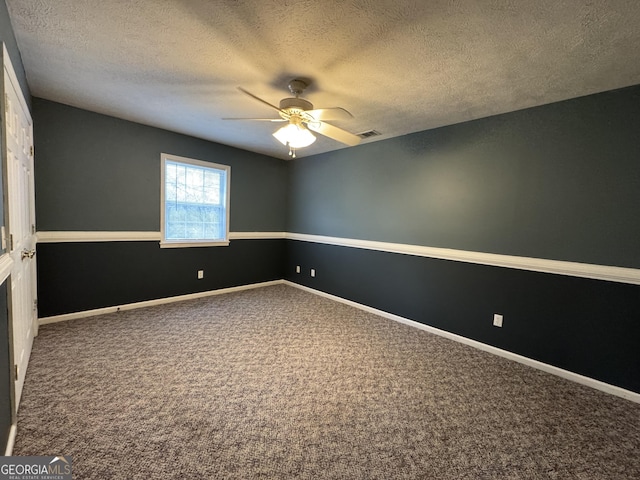 spare room with carpet floors, a textured ceiling, and ceiling fan