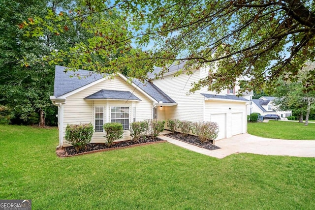 view of front of property with a front yard and a garage