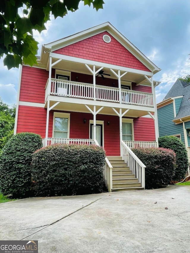 view of front of property with a balcony and ceiling fan