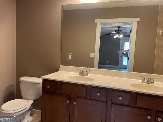 bathroom with tile patterned floors, ceiling fan, vanity, and toilet