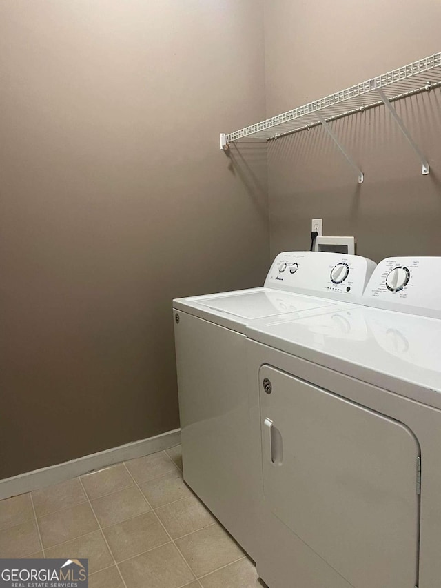 laundry room with light tile patterned floors and washer and dryer