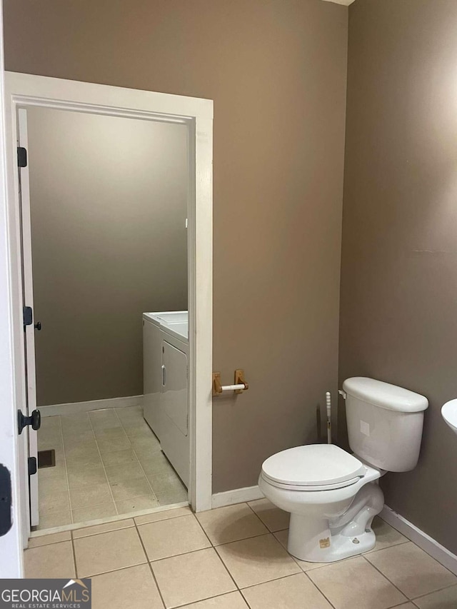 bathroom featuring vanity, tile patterned floors, separate washer and dryer, and toilet