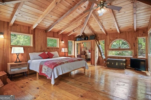 bedroom with multiple windows, light hardwood / wood-style flooring, and wooden ceiling