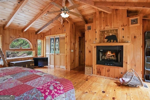 bedroom with wood ceiling, wood-type flooring, wood walls, and lofted ceiling with beams