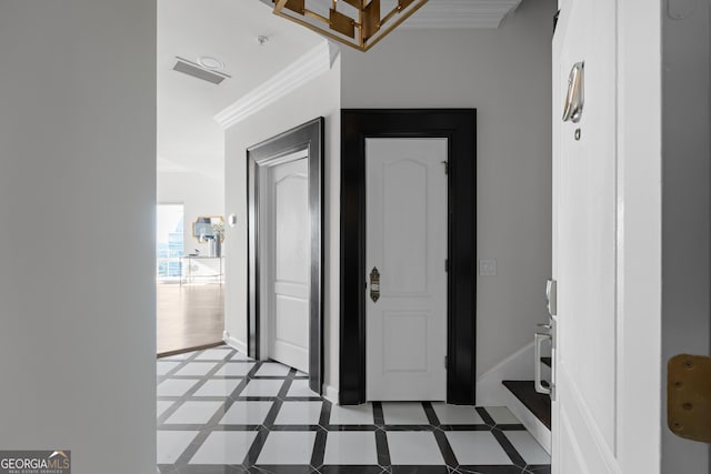 corridor featuring light tile patterned floors and ornamental molding