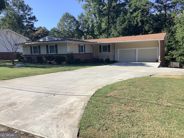 single story home featuring brick siding, a garage, concrete driveway, and a front yard