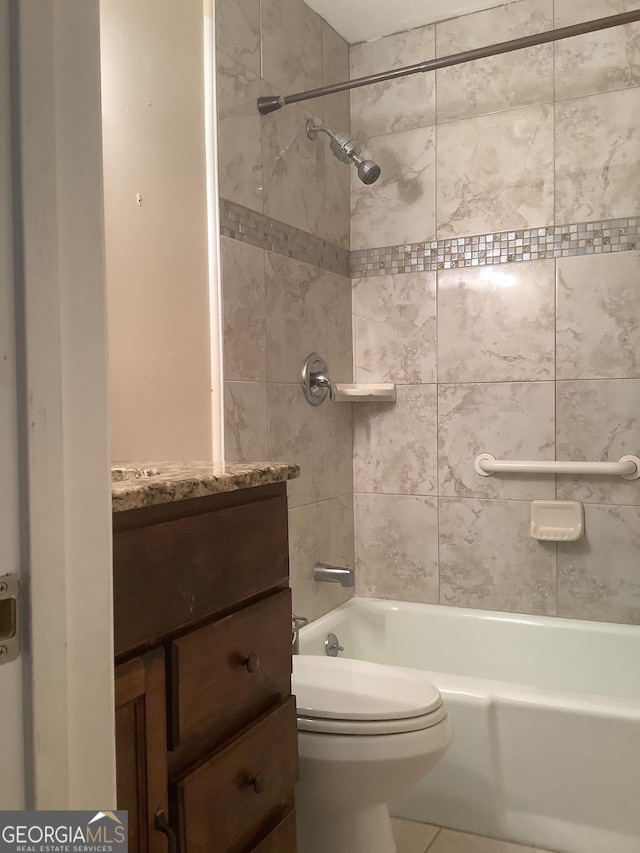 bathroom featuring vanity, toilet, and washtub / shower combination