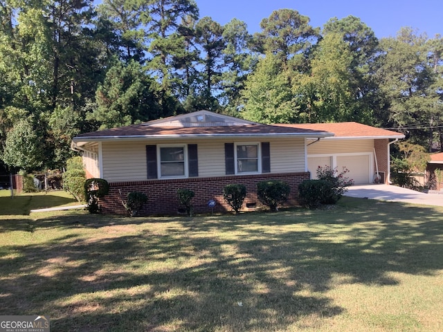 view of front of home featuring a front yard, an attached garage, brick siding, and concrete driveway