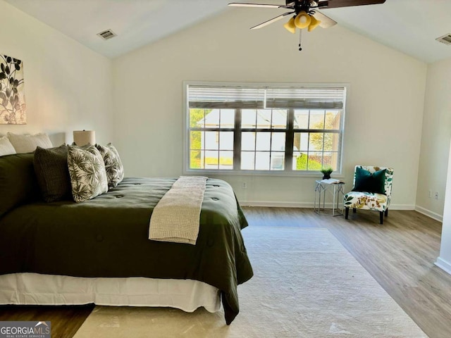 bedroom with wood-type flooring, lofted ceiling, and ceiling fan