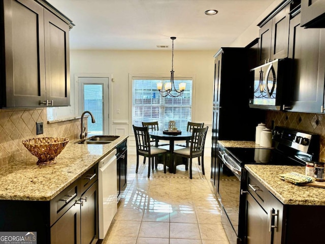 kitchen with dishwashing machine, a chandelier, light stone countertops, sink, and electric range