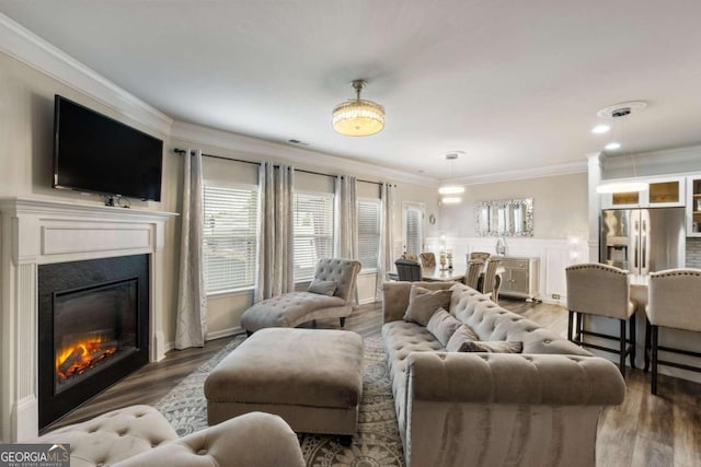 living room featuring ornamental molding and hardwood / wood-style floors