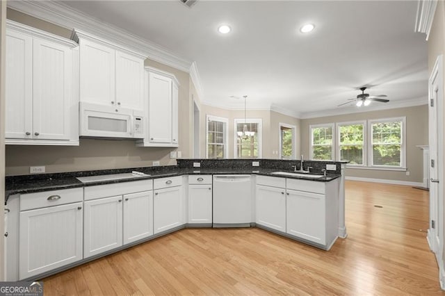 kitchen featuring ceiling fan with notable chandelier, light wood-type flooring, white appliances, and sink