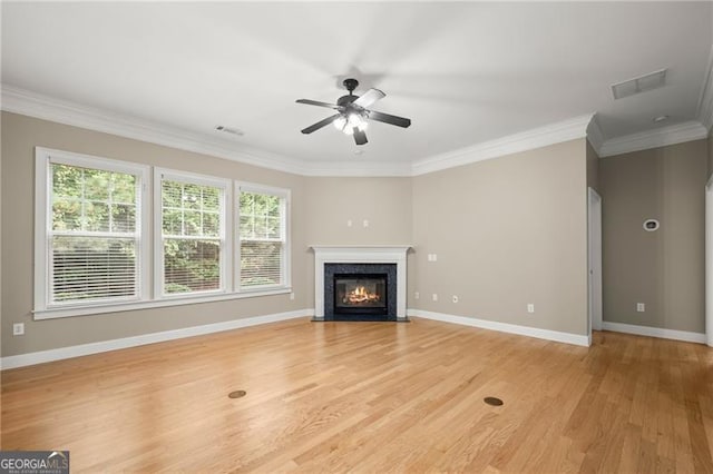 unfurnished living room featuring ceiling fan, light hardwood / wood-style flooring, and ornamental molding