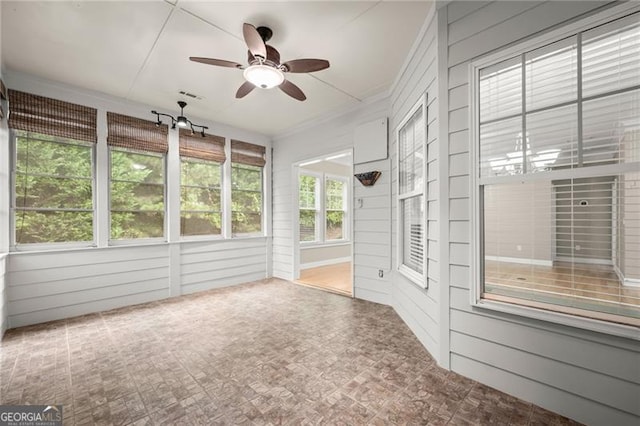 unfurnished sunroom featuring ceiling fan