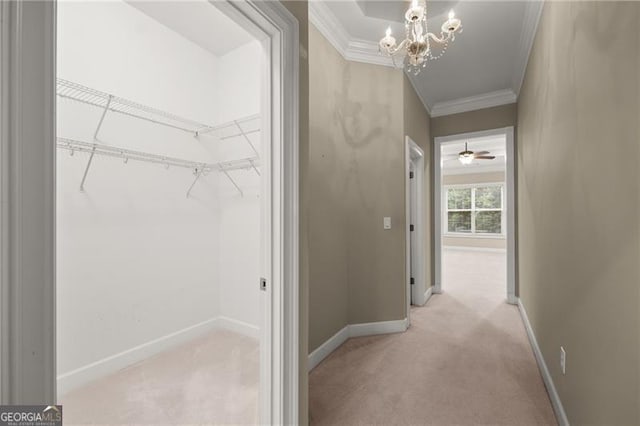 interior space featuring a notable chandelier, light colored carpet, and crown molding