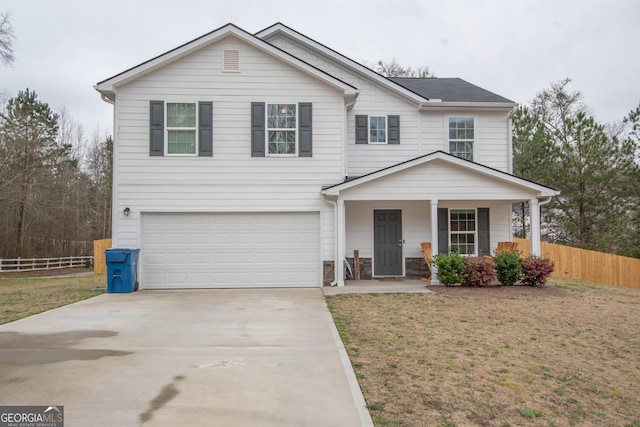 view of front of house featuring a front yard, a garage, and a porch