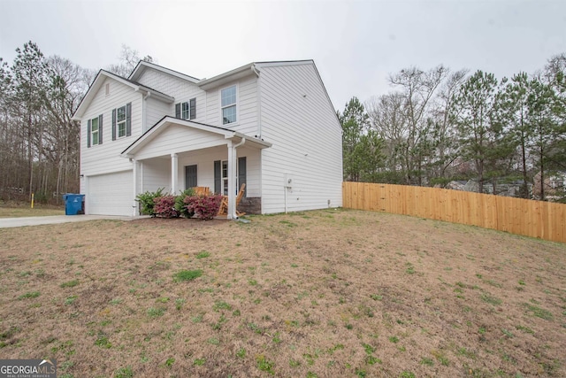 view of front of house featuring a front lawn, a porch, and a garage