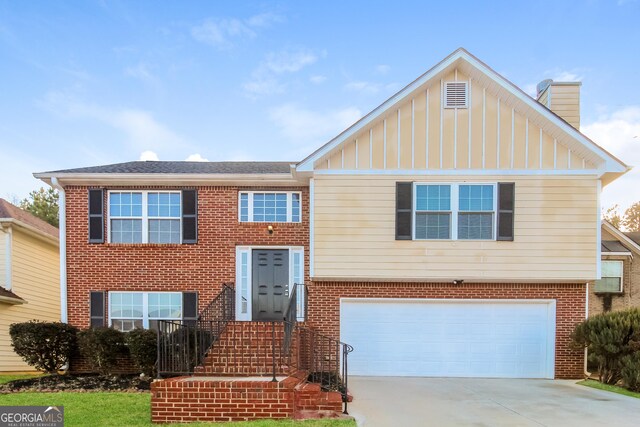 bi-level home with a front yard and a garage