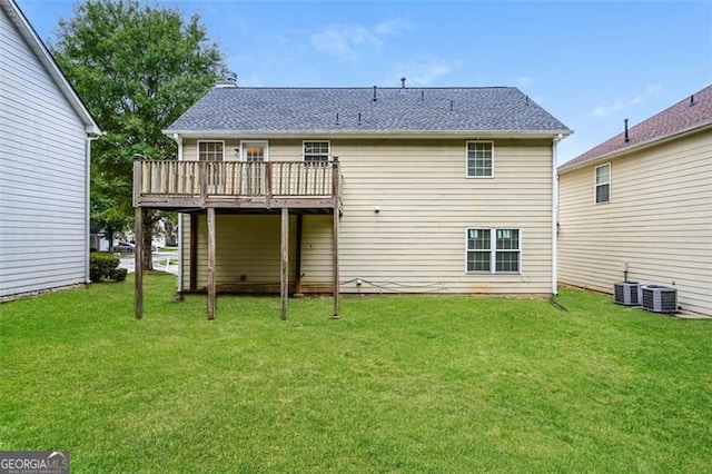 back of house with central AC unit, a yard, and a wooden deck