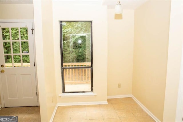 doorway with light tile patterned floors