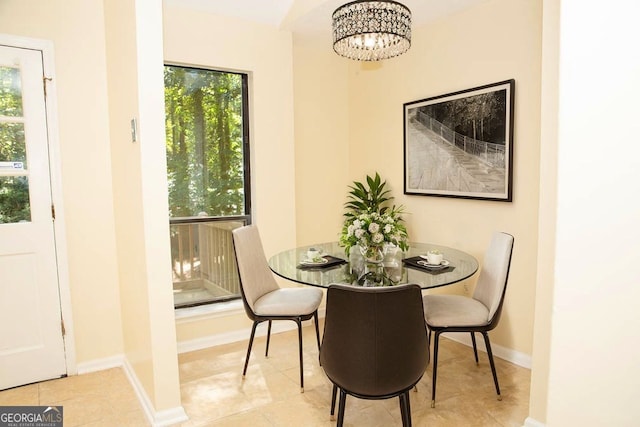 tiled dining room featuring an inviting chandelier