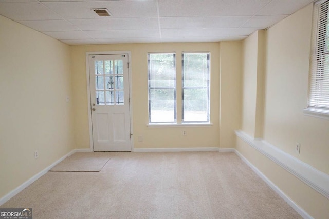 entryway with light carpet and a drop ceiling