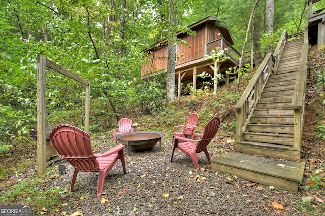 view of yard featuring a fire pit and a deck