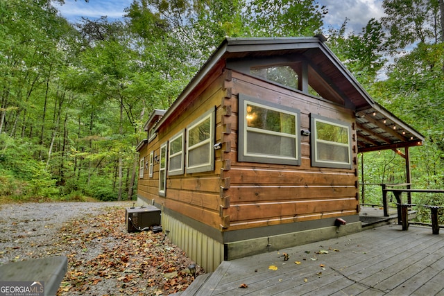 view of home's exterior featuring central AC and a wooden deck