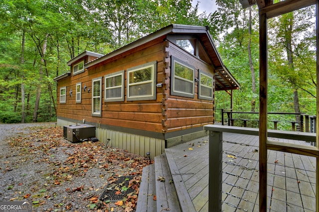 view of home's exterior featuring a wooden deck and cooling unit