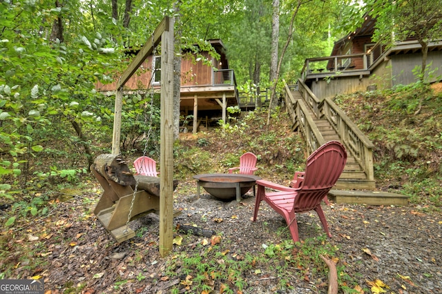 view of yard featuring a fire pit and a wooden deck