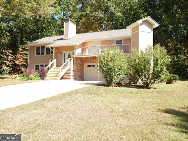 tri-level home with a garage and a front lawn