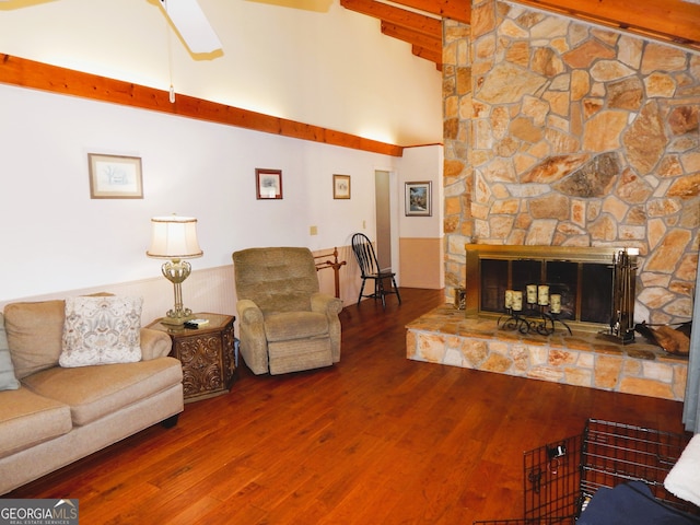 living room featuring beamed ceiling, a fireplace, high vaulted ceiling, hardwood / wood-style floors, and ceiling fan