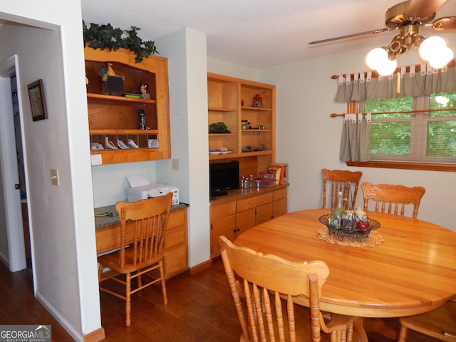 dining room featuring ceiling fan and dark wood-type flooring