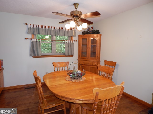 dining space featuring ceiling fan and dark hardwood / wood-style flooring