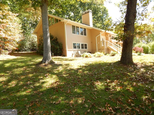 381 Hidden Lakeview Cir, Hiawassee, GA 30546 - back of house with a chimney and a yard