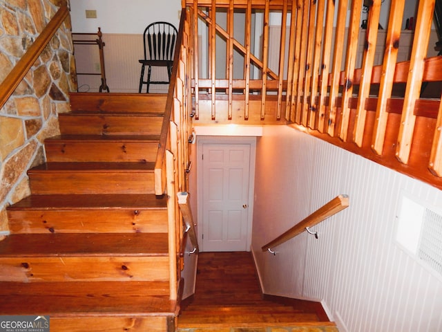 staircase with wood-type flooring