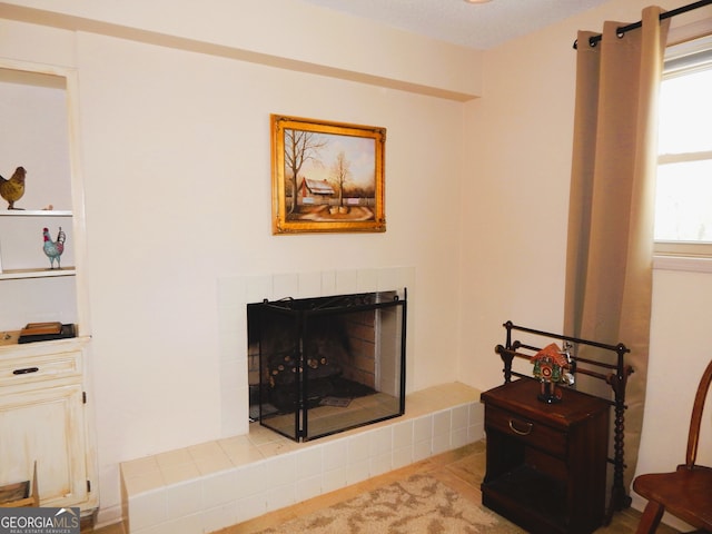 living room featuring a tile fireplace