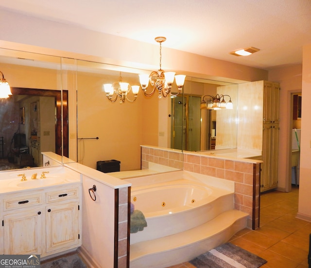 bathroom with independent shower and bath, vanity, an inviting chandelier, and tile patterned floors