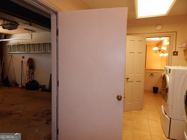 interior space with light tile patterned floors, washer / clothes dryer, and a chandelier