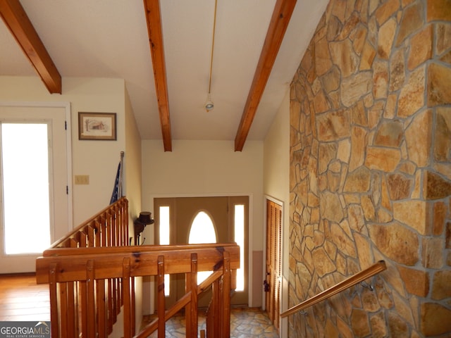 foyer featuring beam ceiling and light hardwood / wood-style flooring