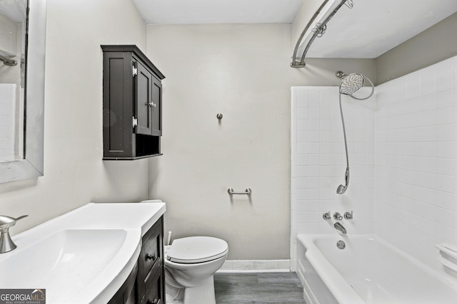 full bathroom featuring vanity, toilet,  shower combination, and wood-type flooring