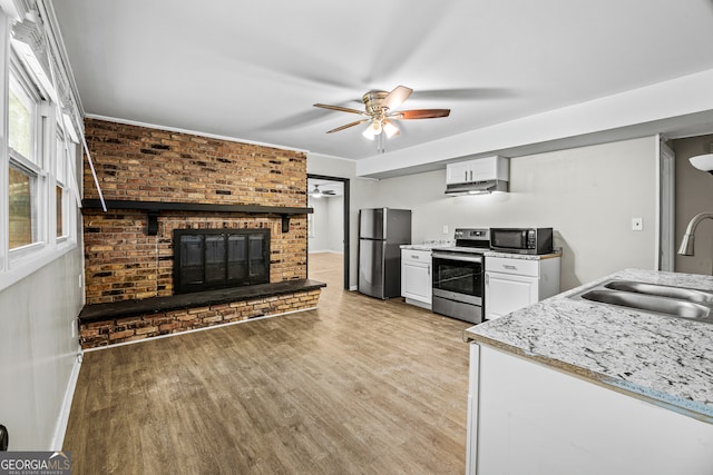 kitchen with light hardwood / wood-style floors, ceiling fan, stainless steel appliances, and white cabinets