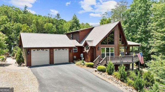 cabin with a garage and a porch