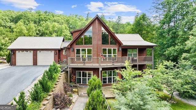 log-style house with a balcony and a garage