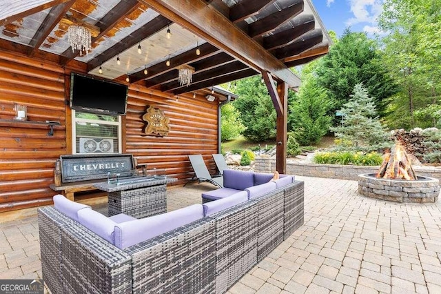 view of patio / terrace with an outdoor living space with a fire pit