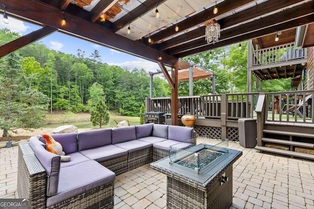 view of patio featuring an outdoor living space with a fire pit and a wooden deck